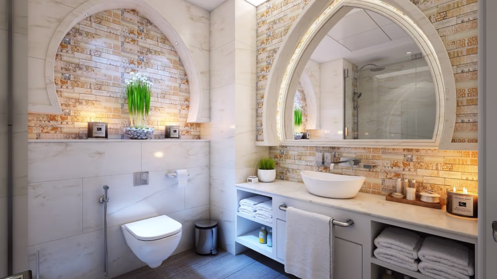 Trendy bathroom renovation with half circular mirror, countertop and toiler with candles and plants for a backdrop