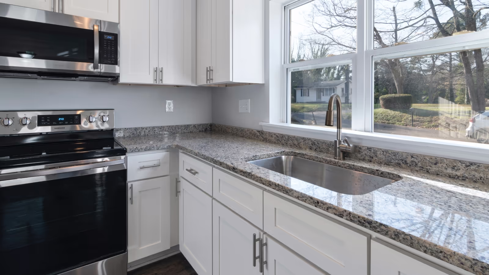 Modern kitchen with white cabinets and granite countertop
