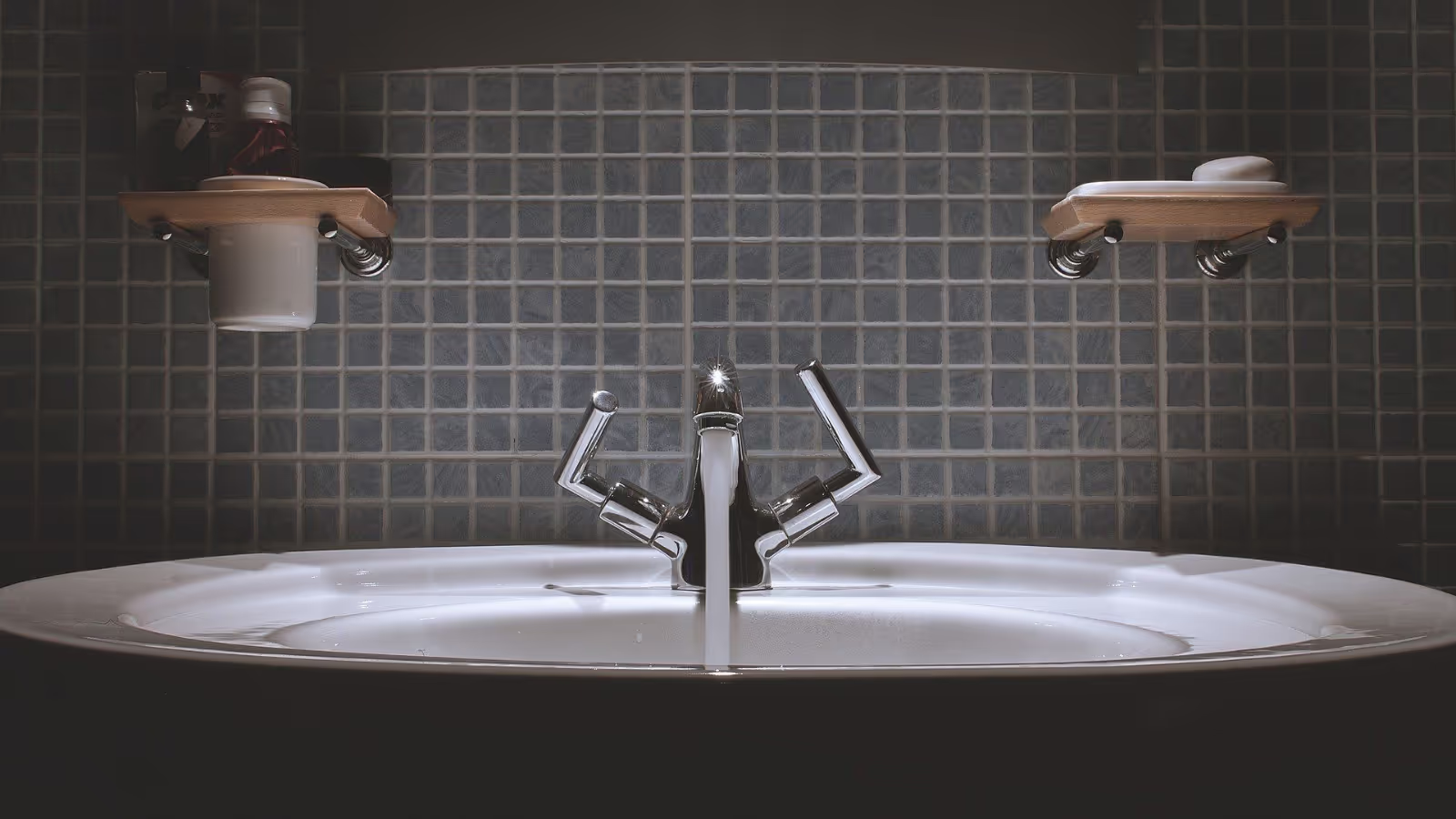 Close up of bathroom sink and subway backsplash tiles.