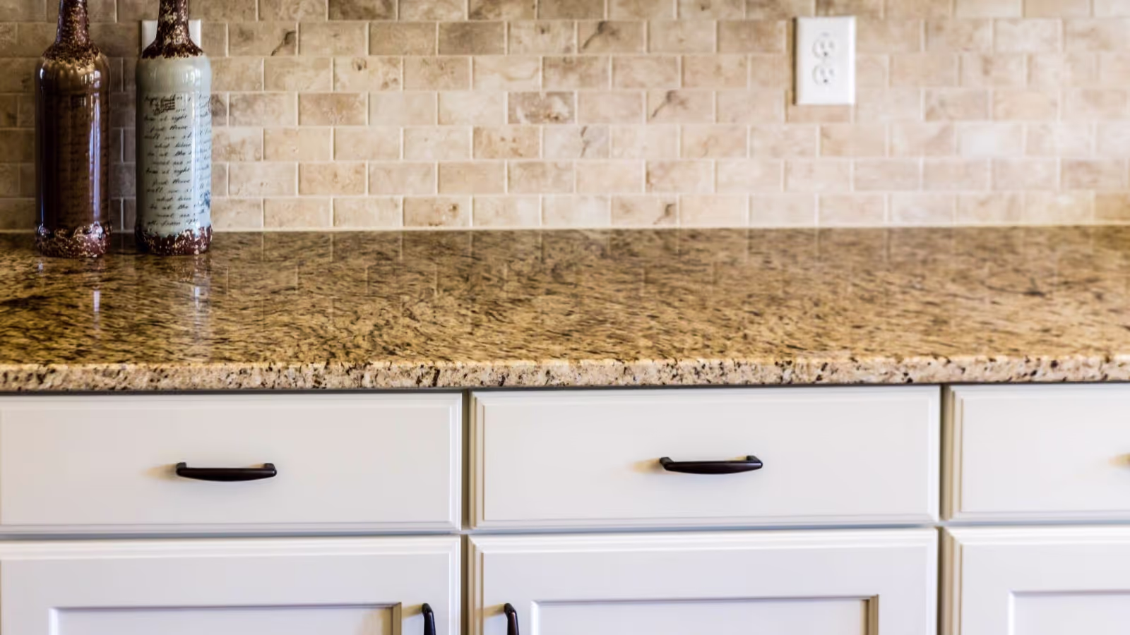 Granite countertop with complementary tile backsplash in Arizona kitchen